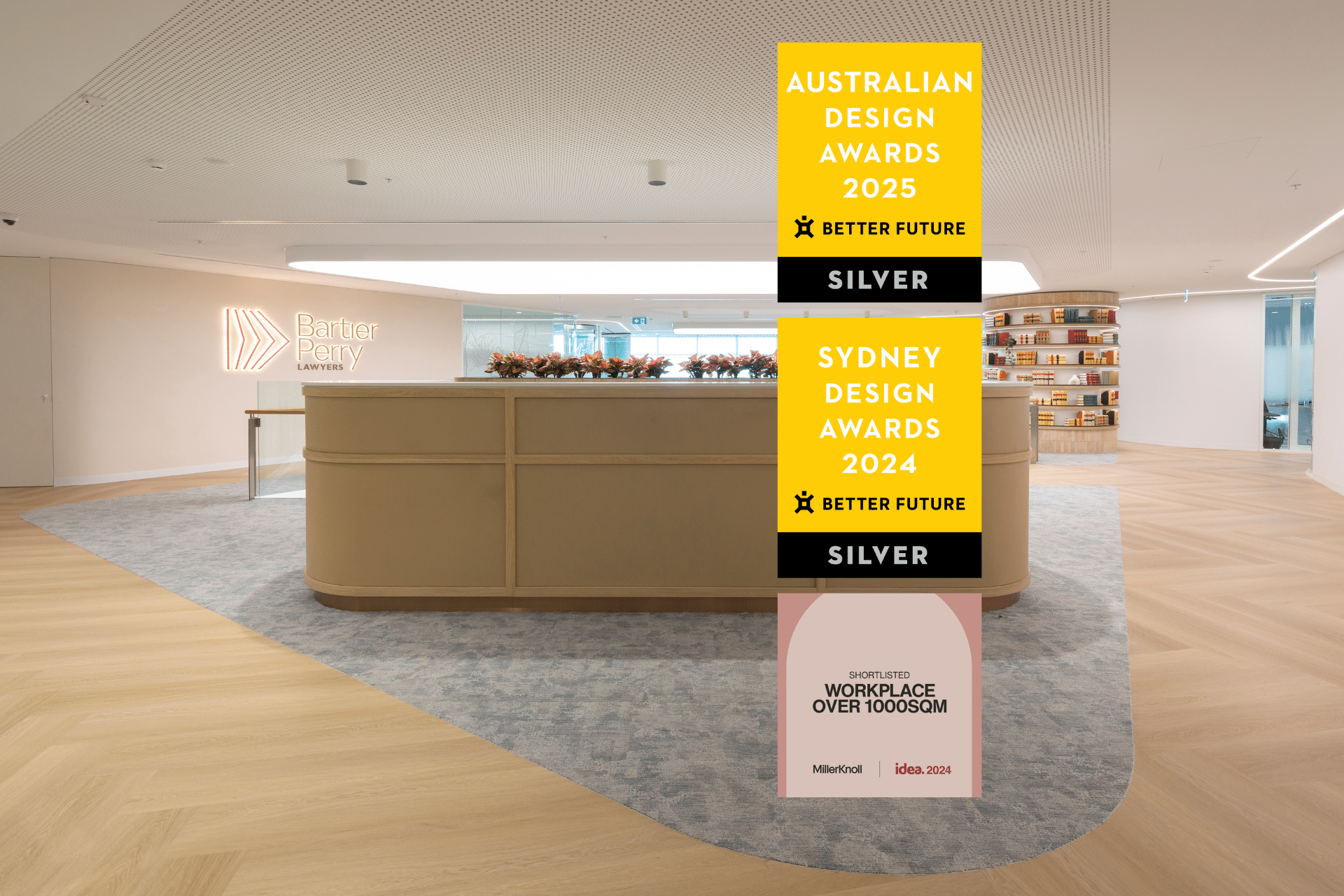 Stylish office reception with modern furniture, warm lighting, and an open layout. Awards for Australian and Sydney Design displayed in the foreground.