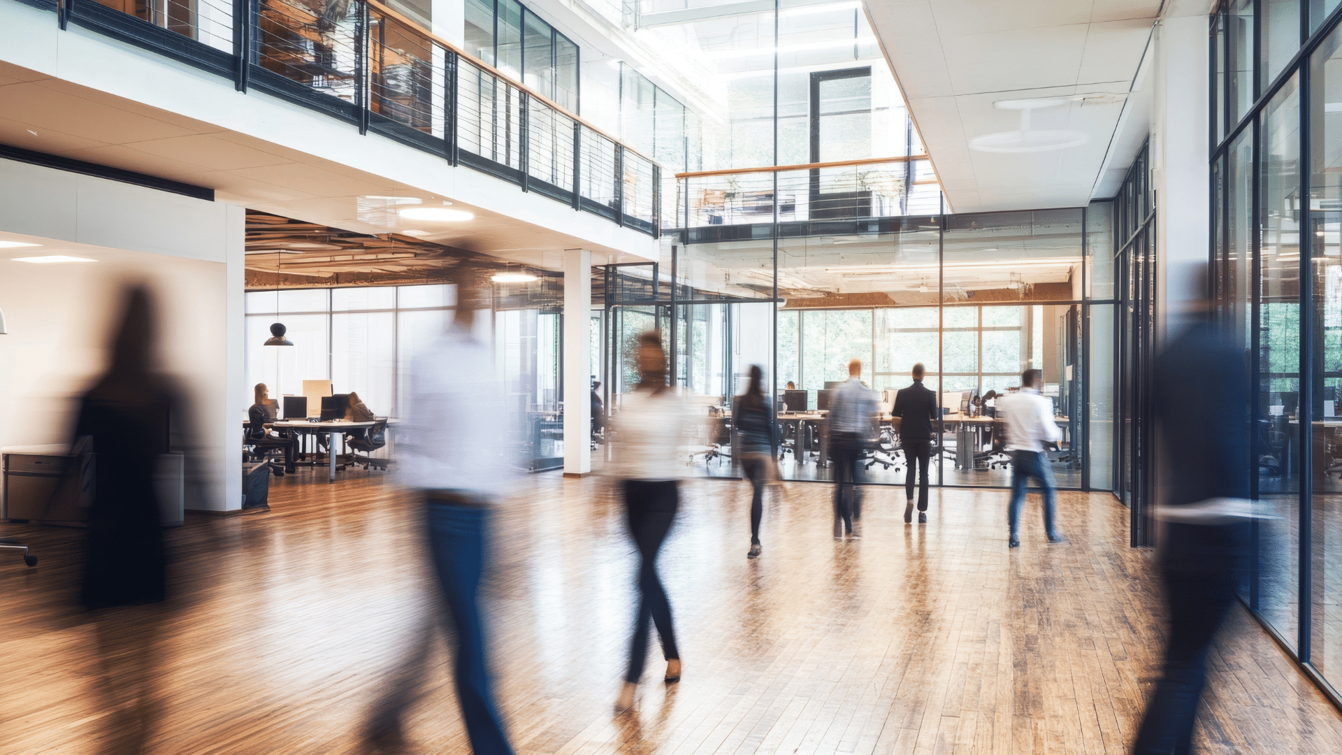 People walking in an open, bright and light office space.